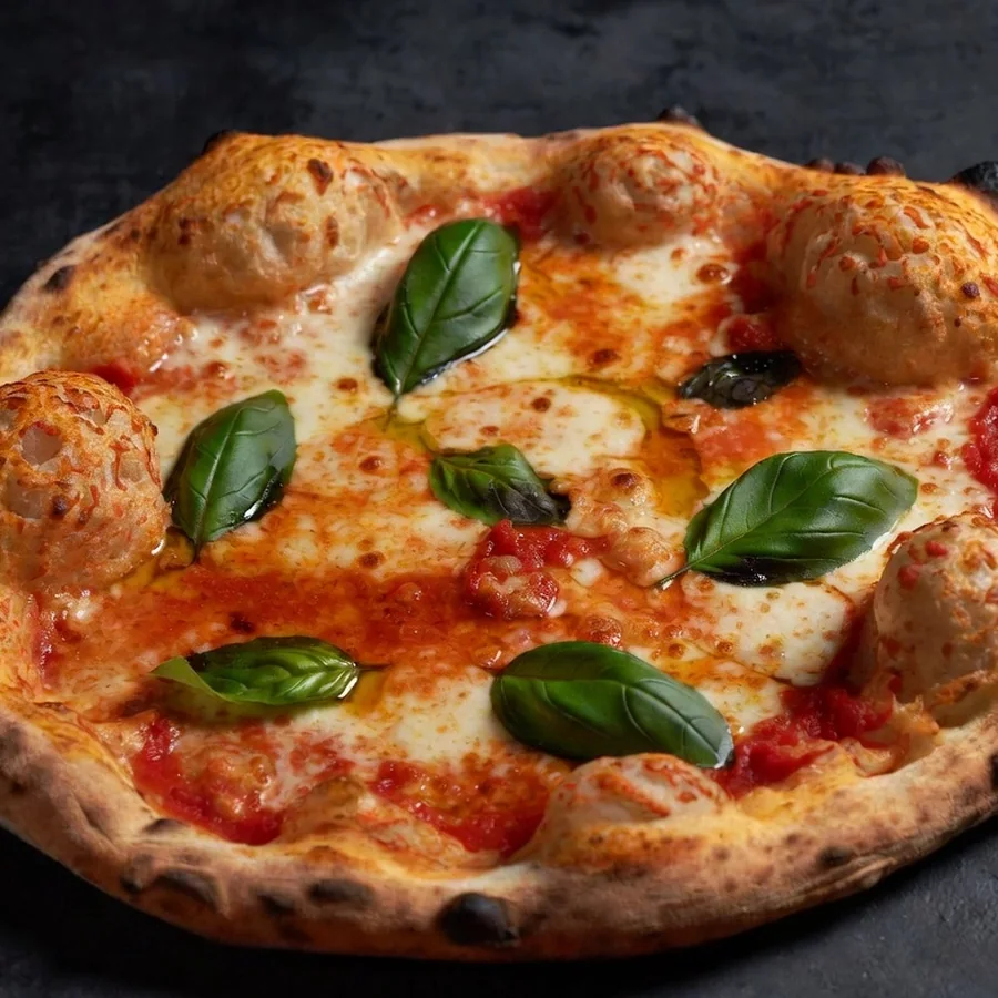Pizza from the wood-fired oven with a charred rim